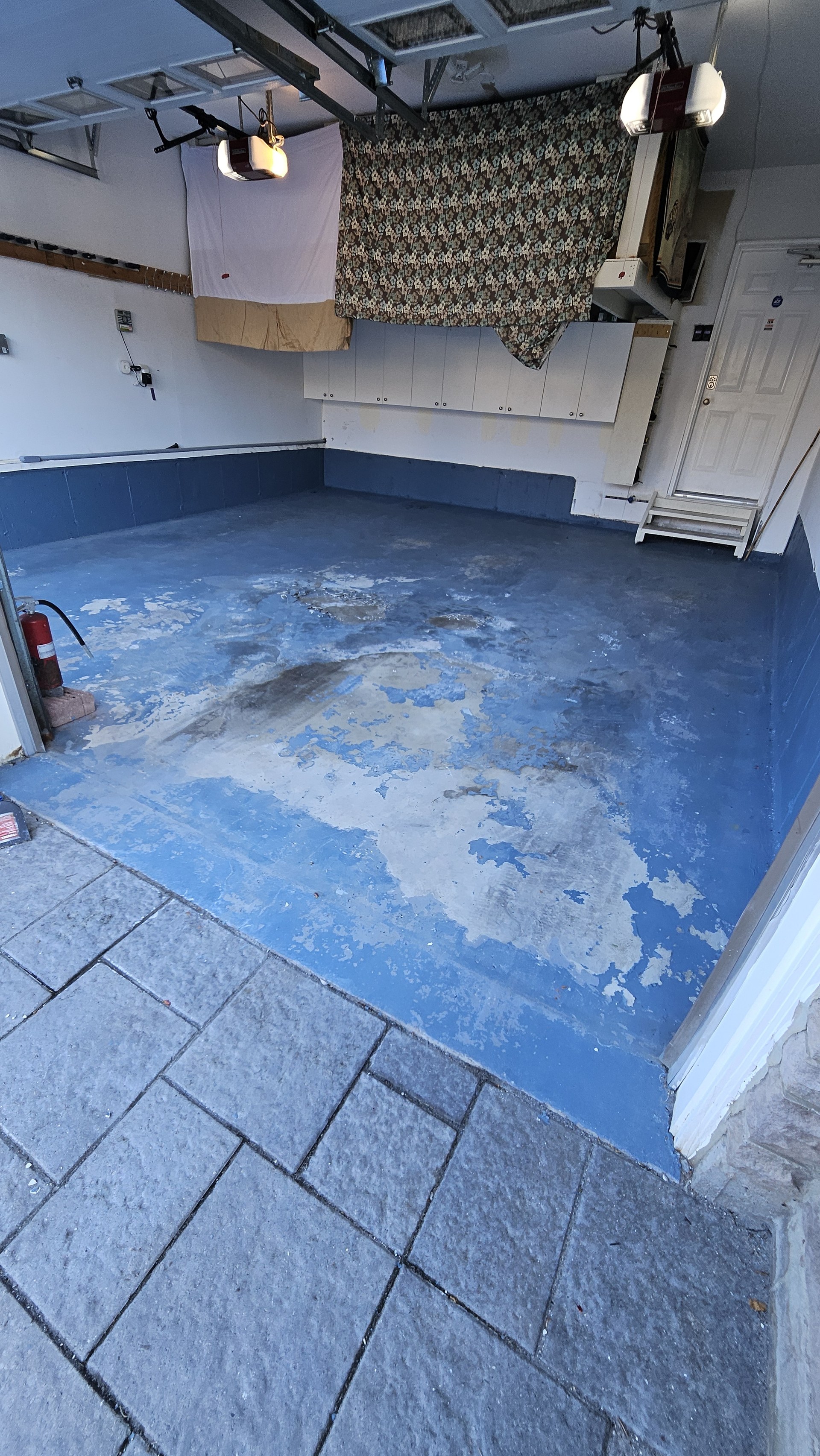 Before — failing multi-layer blue painted garage floor in Brampton