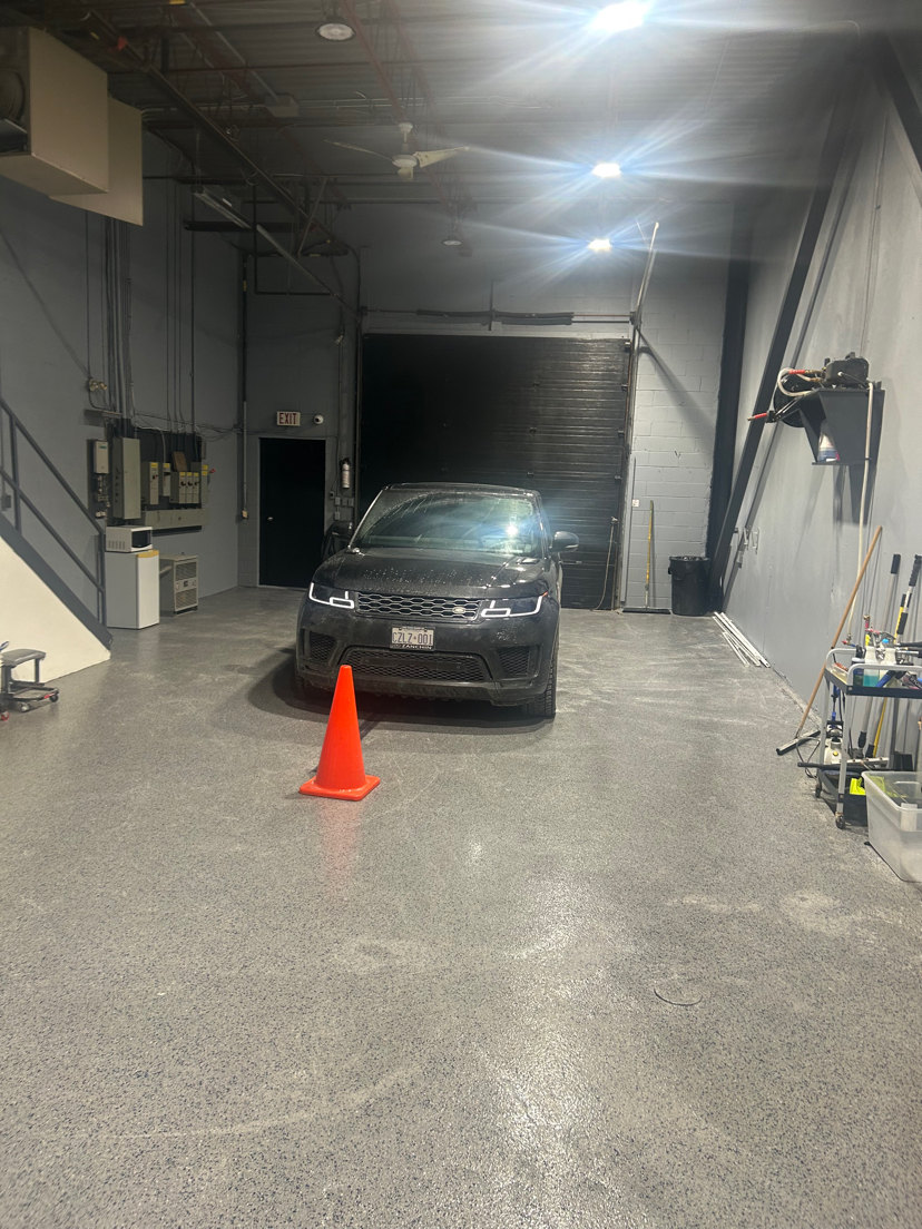 Completed commercial flake epoxy floor by Prime Surface Systems Inc. at a North York automotive detailing centre